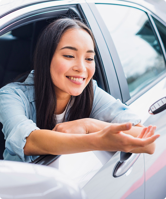 Smiling woman enjoying short-term car rental in Singapore.