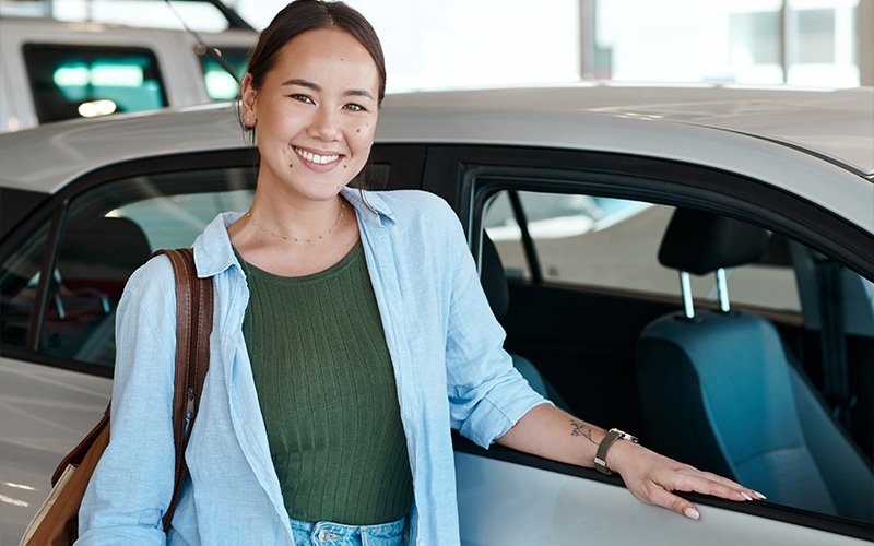 lady-smiling-beside-a-car