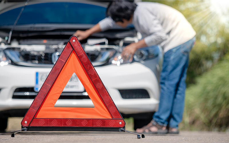 Emergency-stop-sign-placed-near-broken-down-rental-car